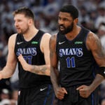Dallas Mavericks guard Kyrie Irving (11) celebrates after making a 3-point shot against the Minnesota Timberwolves during the second half of Game 2 of the NBA basketball Western Conference finals, Friday, May 24, 2024, in Minneapolis.