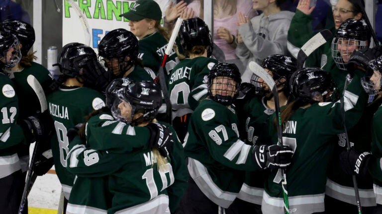 Boston players, including defender Jess Healey (97), celebrate an overtime win against Montreal in a PWHL playoff hockey game Tuesday, May 14, 2024, in Lowell, Mass.