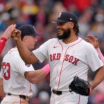 Boston Red Sox's Kenley Jansen, right, celebrates with Garrett Cooper, left, and Romy Gonzalez, center, after they defeated the Washington Nationals in a baseball game, Sunday, May 12, 2024, in Boston.