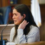 Allie McCabe breaks into tears on the stand Wednesday when recounting the harassment that she and her family have faced.