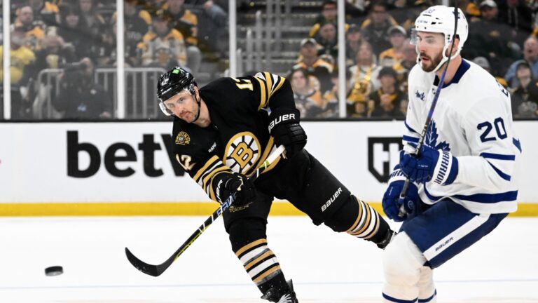 BOSTON, MASSACHUSETTS - APRIL 20: Kevin Shattenkirk #12 of the Boston Bruins clears the puck past Joel Edmundson #20 of the Toronto Maple Leafs during the third period in Game One of the First Round of the 2024 Stanley Cup Playoffs at TD Garden on April 20, 2024 in Boston, Massachusetts.