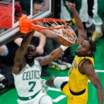Celtics guard Jaylen Brown dunks the ball against Indiana Pacers forward Aaron Nesmith during the first quarter.