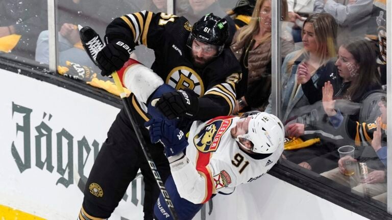 Boston Bruins' Pat Maroon (61) checks Florida Panthers' Oliver Ekman-Larsson (91) during the first period in Game 3 of an NHL hockey Stanley Cup second-round playoff series Friday, May 10, 2024, in Boston.