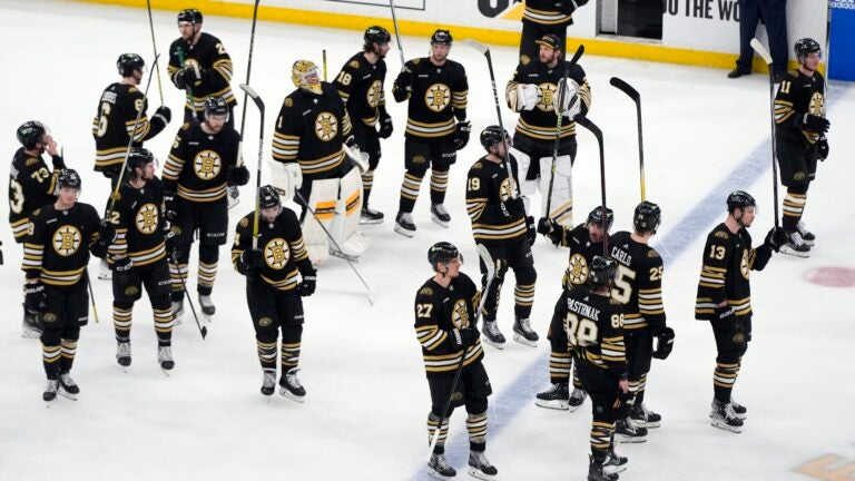 The Boston Bruins raise their sticks to the fans after losing to the Florida Panthers in Game 6 of an NHL hockey Stanley Cup second-round playoff series, Friday, May 17, 2024, in Boston.