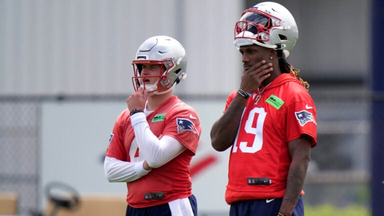 New England Patriots quarterbacks Bailey Zappe, left, and Joe Milton III, right, stand together during an NFL football practice, Monday, May 20, 2024, in Foxborough, Mass.