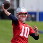 New England Patriots quarterback Drake Maye winds up to pass the the ball during an NFL football offseason workout, Monday, May 20, 2024, in Foxborough, Mass.
