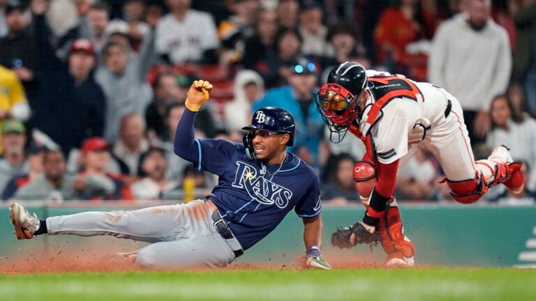 Tampa Bay's Richie Palacios scores against Red Sox catcher Connor Wong during the sixth inning.