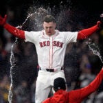 Romy Gonzalez of the Red Sox is doused with water after his game-winning RBI single in the 12th inning.