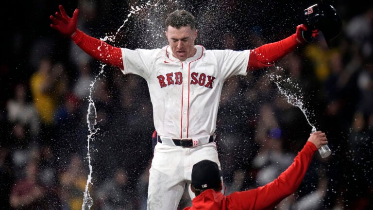 Romy Gonzalez of the Red Sox is doused with water after his game-winning RBI single in the 12th inning.