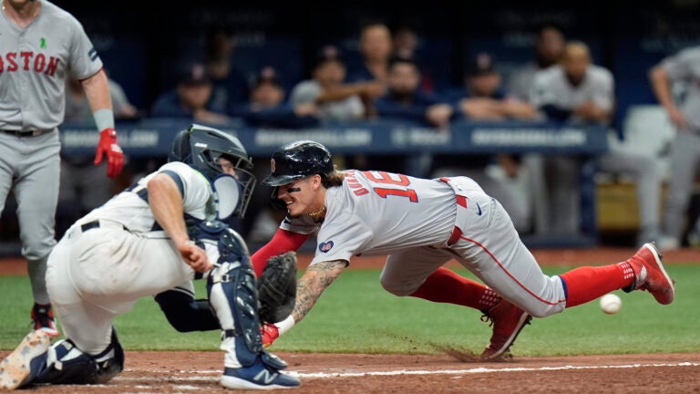 Jarren Duran of the Red Sox steals home ahead of the throw to Tampa Bay catcher Ben Rortvedt during the eighth inning.