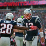 Patriots quarterback Tom Brady (right) celebrates with running back James White (left) after they hooked up for a third quarter touchdown pass, their second of the game. Gillette Stadium Cincinnati Bengals at New England Patriots - 3rd quarter action.