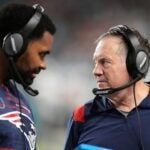 Jerod Mayo and Bill Belichick talk on the sidelines during a game against the Miami Dolphins in 2022. Mayo recently took over for Belichick as head coach of the New England Patriots.
