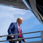 Former President Donald Trump boards his plane in Miami.