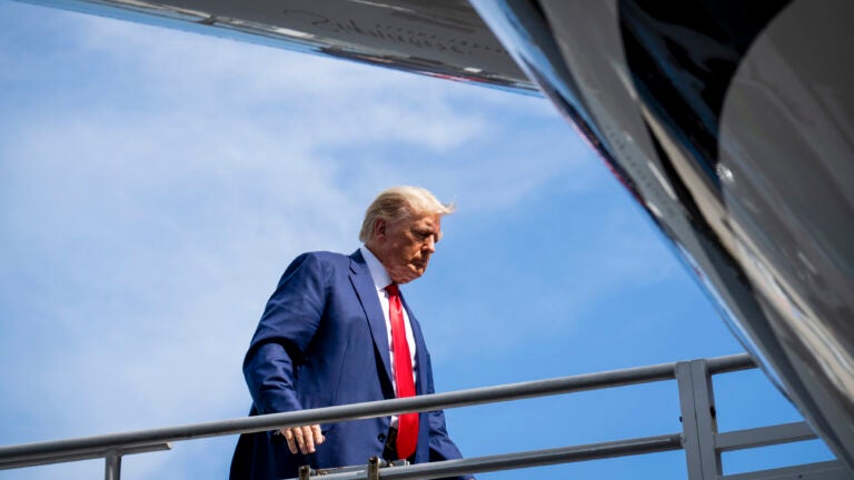 Former President Donald Trump boards his plane in Miami.