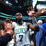 Boston Celtics guard Jaylen Brown (7) high 5’s fans as he exits the court following the Celtics win in overtime. The Boston Celtics host the Indiana Pacers in Game 1 of the NBA Eastern Conference Finals.