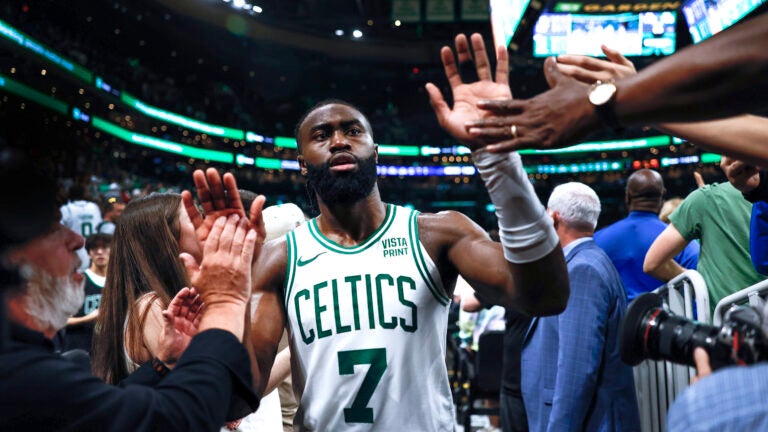 Boston Celtics guard Jaylen Brown (7) high 5’s fans as he exits the court following the Celtics win in overtime. The Boston Celtics host the Indiana Pacers in Game 1 of the NBA Eastern Conference Finals.