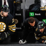 Boston Bruins Dustin Stuck head athletic trainer checking in on left wing Brad Marchand (63) who was injured after a hit by Florida Panthers center Sam Bennett (9) during first period action in game three of the Eastern Conference NHL second round Playoff game at TD Garden.