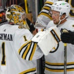 Boston Bruins goalie Jeremy Swayman (1) celebrates their 2-1 victory with teammate Charlie McAvoy (73) against the Florida Panthers during game five of the Eastern Conference NHL second round Playoff game at Amerant Bank Arena.