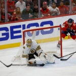 Boston Bruins goalie Jeremy Swayman (1) keeps the puck out of the new as Florida Panthers play without a goalie during third period action in game five of the Eastern Conference NHL second round Playoff game at Amerant Bank Arena.