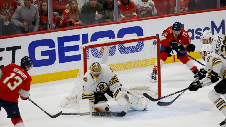 Boston Bruins goalie Jeremy Swayman (1) keeps the puck out of the new as Florida Panthers play without a goalie during third period action in game five of the Eastern Conference NHL second round Playoff game at Amerant Bank Arena.