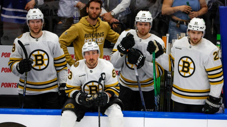 Boston Bruins left wing Brad Marchand (63) and teammates watching from the bench as the Toronto Maple Leafs celebrate their 2-1 victory in game six of the Eastern Conference NHL Playoffs at Scotiabank Arena.