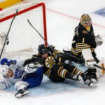 Boston Bruins right defenseman Charlie McAvoy (73 and Toronto Maple Leafs left wing Tyler Bertuzzi (59) getting tangled up in the net behind goalie Jeremy Swayman (1) during the first period in game five of the Eastern Conference NHL Playoffs at TD Garden.