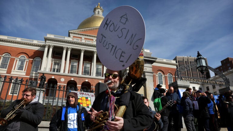 A housing justice protest in front of the State House