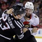 NEWARK, NEW JERSEY - MARCH 23: Mark Kastelic #12 of the Ottawa Senators fights Kurtis MacDermid #23 of the New Jersey Devils during the first period at the Prudential Center on March 23, 2024 in Newark, New Jersey.
