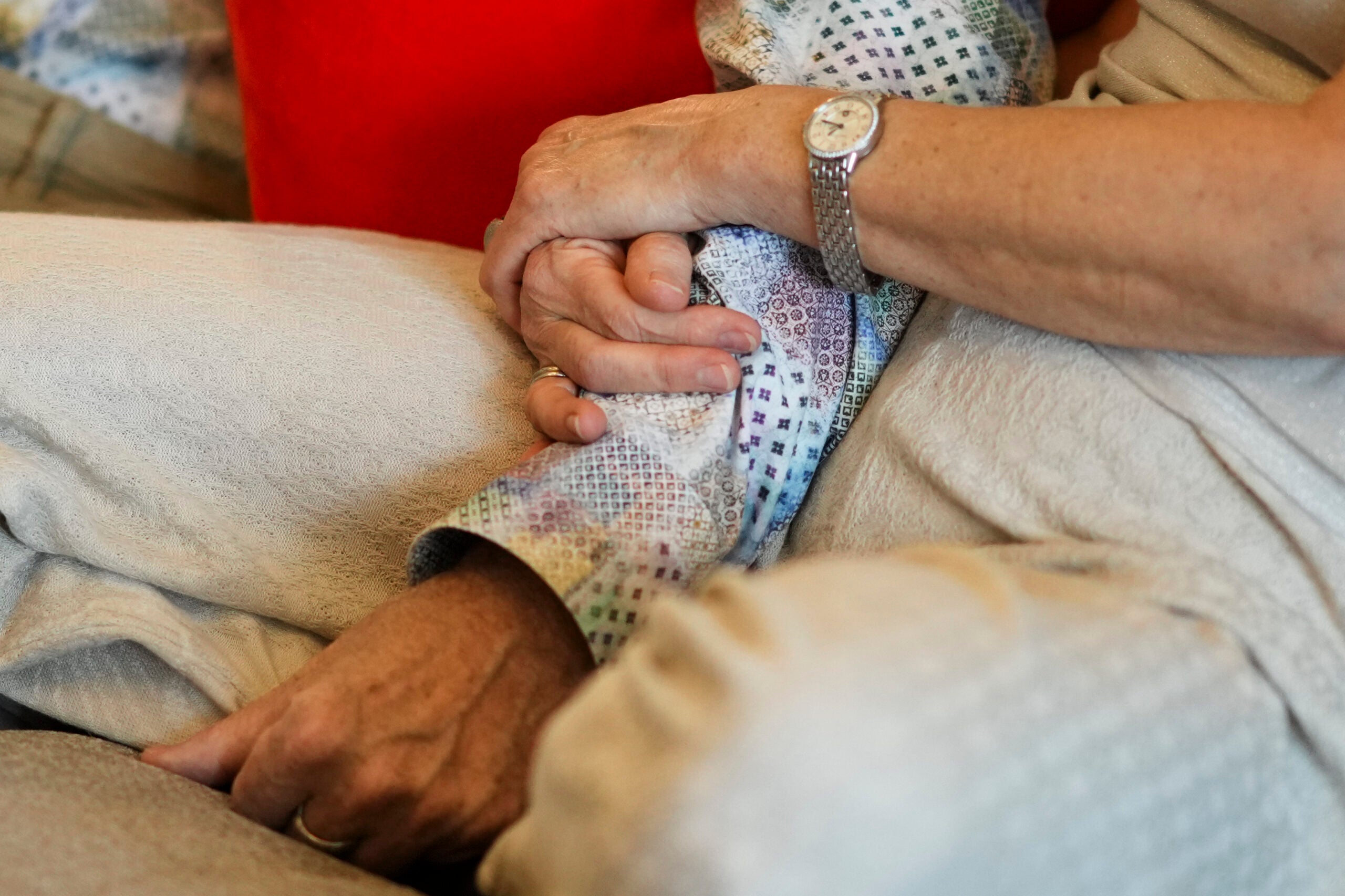 Anett Bommer holds the arm of her husband Michael Bommer. 