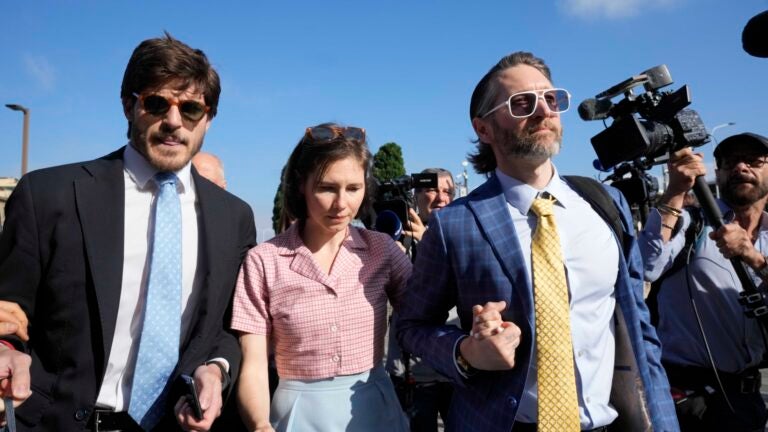 Amanda Knox arrives flanked by her husband Christopher Robinson, right, and her lawyer Luca Luparia Donati.