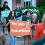Members of Junior Newtown Action Alliance hold signs during a rally.