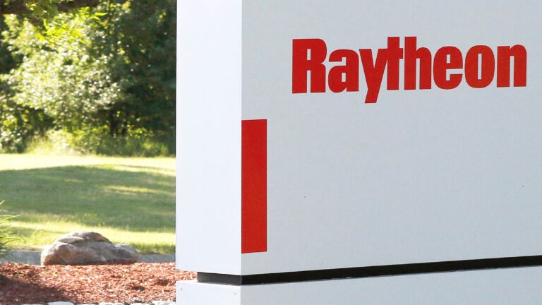 A sign stands at the road leading to the Raytheon facility in Marlborough, Mass.