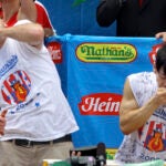 Joey Chestnut works to outpace former champion Takeru Kobayashi in New York in 2009.