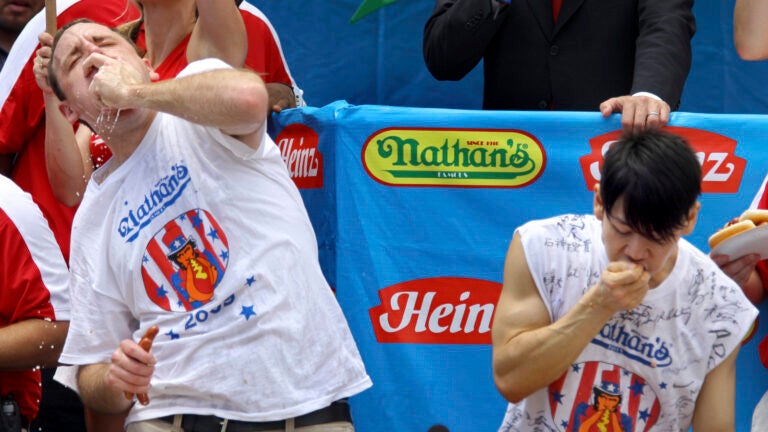 Joey Chestnut works to outpace former champion Takeru Kobayashi in New York in 2009.