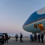 President Joe Biden walks to his limousine as he arrives on Air Force One.