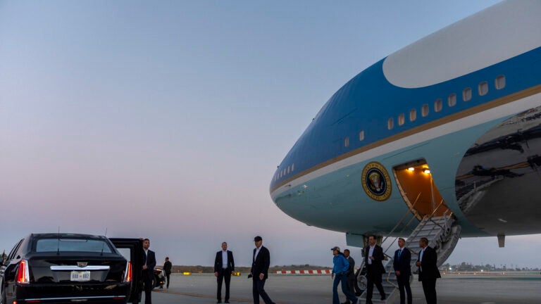 President Joe Biden walks to his limousine as he arrives on Air Force One.