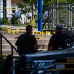 Officials secure the scene of a shooting at the Brooklands Plaza Splash Pad in Rochester Hills, Mich.