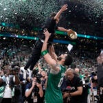 Boston Celtics forward Jayson Tatum lifts his son Deuce.