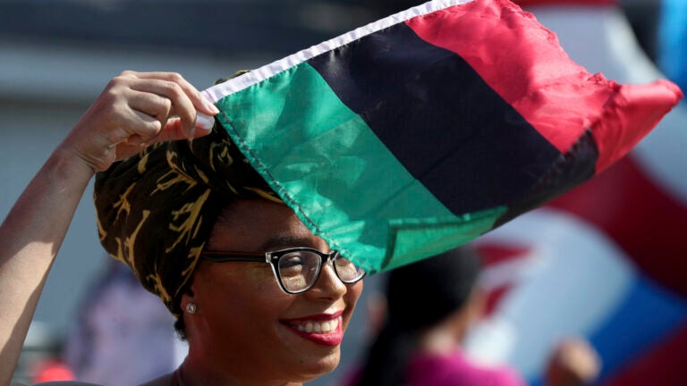 Crystal Baziel holds the Pan-African flag.