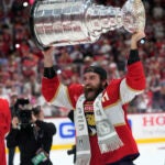 Florida Panthers defenseman Aaron Ekblad raises the NHL hockey Stanley Cup trophy.