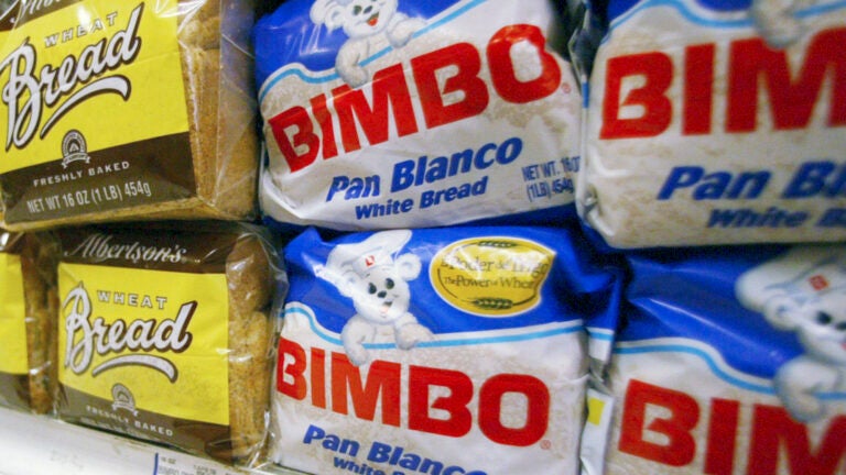 Bimbo bread is displayed on a shelf at a market.