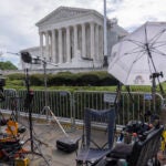 Broadcast media equipment is set up outside the Supreme Court.
