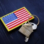 American flag and key from home. VA Streamline Refinance loan concept. Veterans VA