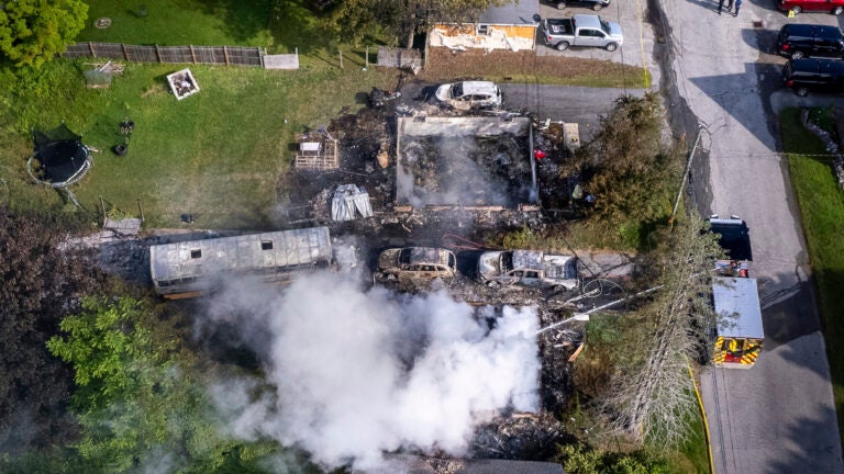 Auburn firefighters hose down the remains of home in Auburn, Maine, early Saturday, June 15, 2024.