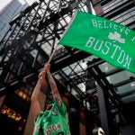 Chris Soldani waves a Celtics flag on Causeway Street outside of TD Garden before game 4 of the Celtics vs Mavericks NBA Finals series.