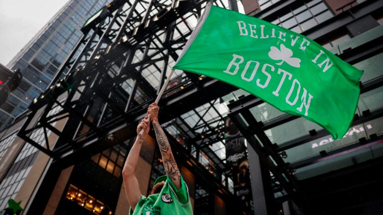 Chris Soldani waves a Celtics flag on Causeway Street outside of TD Garden before game 4 of the Celtics vs Mavericks NBA Finals series.