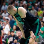 Boston Celtics center Kristaps Porzingis (8) catches his breath during the third quarter in Game 2 of the NBA Finals. The Boston Celtics hosted the Dallas Mavericks at TD Garden on Sunday, June 9, 2024.