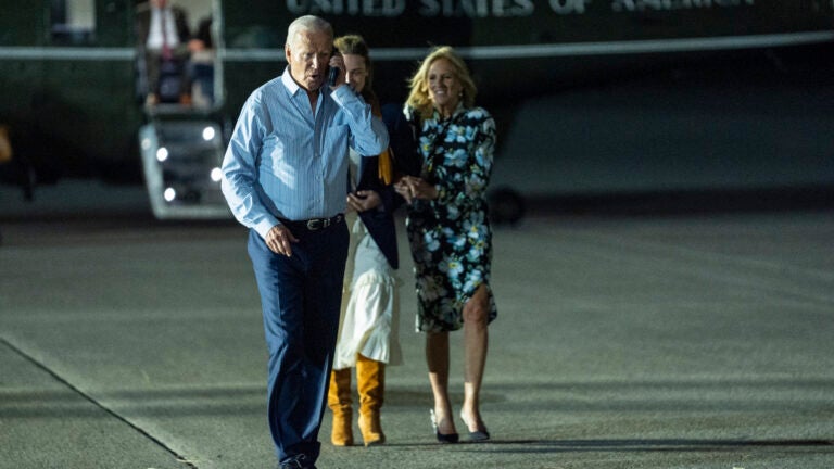 President Joe Biden, left, talks on the phone as he walks to board Air Force One at McGuire Air Force Base, Saturday, June 29, 2024, in Burlington County, N.J.