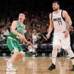 BOSTON, MASSACHUSETTS - JUNE 17: Payton Pritchard #11 of the Boston Celtics and Luka Doncic #77 of the Dallas Mavericks watch Pritchard's half court buzzer beating shot during the second quarter of Game Five of the 2024 NBA Finals at TD Garden on June 17, 2024 in Boston, Massachusetts