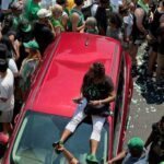 Fans damage firefighters cars during the Celtics Parade on Friday.